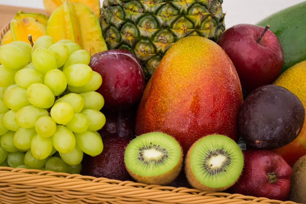 Colorful assortment of fresh fruits including berries, citrus, and tropical varieties